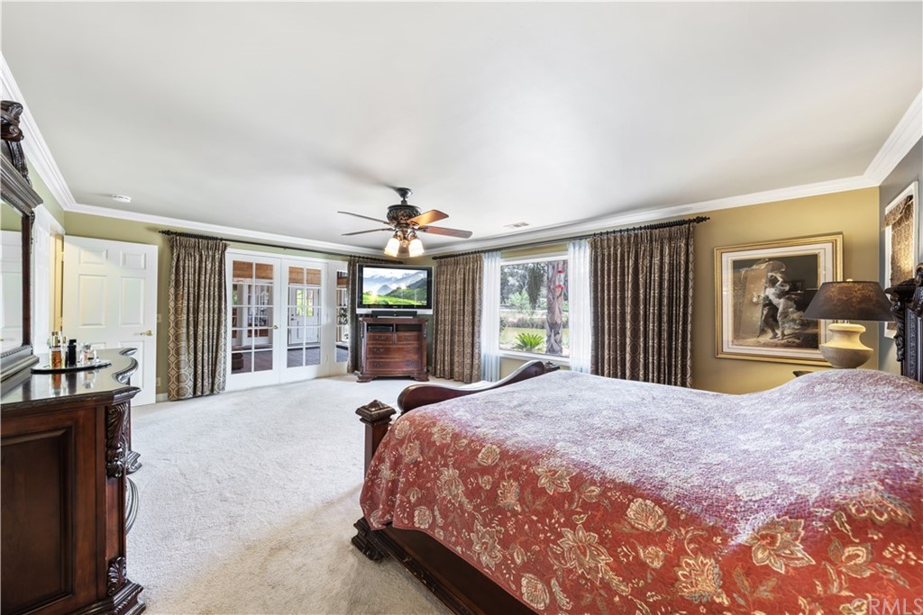 34970 Santa Rita Road Temecula, CA 92592 - Photo 30 of 38 a spacious bedroom with a large bed and a large window