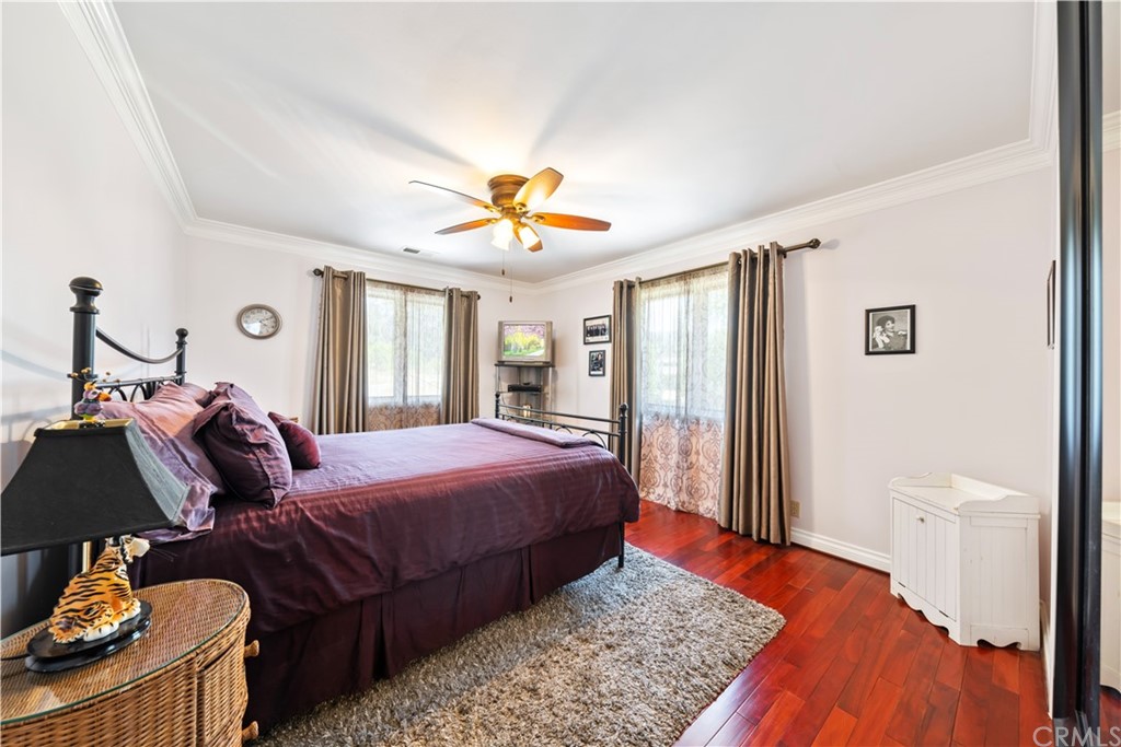 34970 Santa Rita Road Temecula, CA 92592 - Photo 35 of 38 a bedroom with a bed and wooden floor