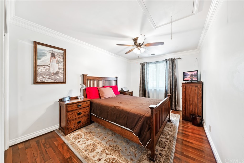 34970 Santa Rita Road Temecula, CA 92592 - Photo 36 of 38 a bedroom with a bed dresser and wooden floor