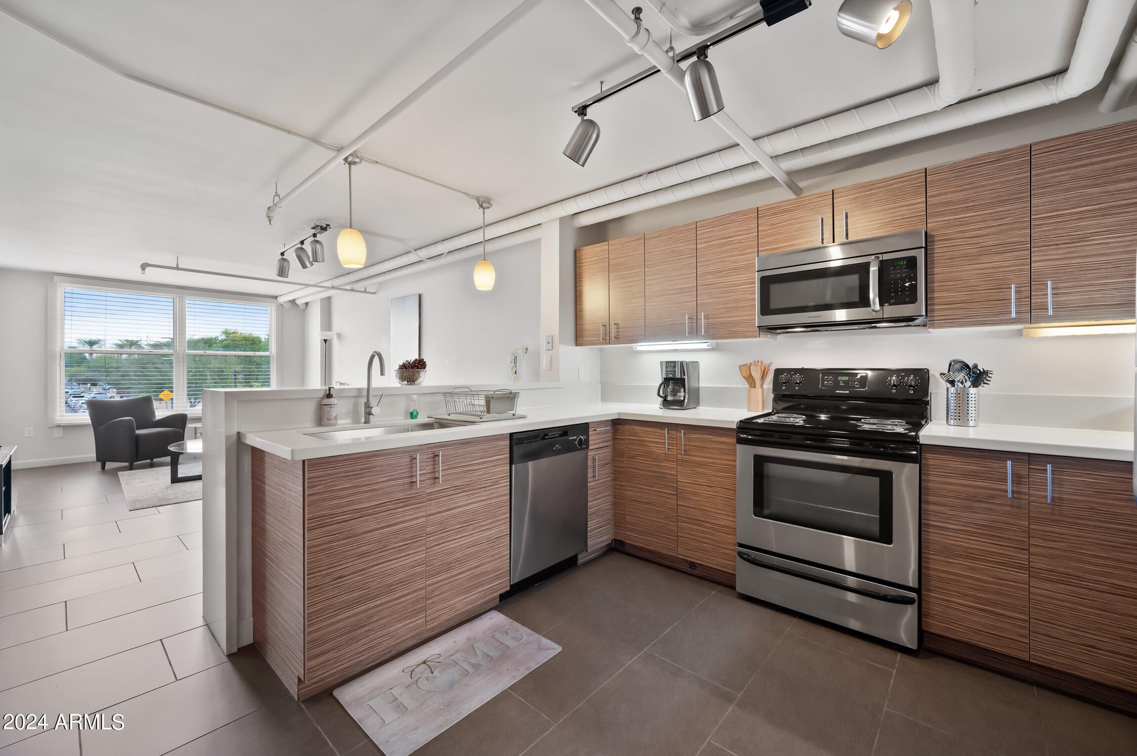 535 West Thomas Road, Unit 212 Phoenix, AZ 85013 - Photo 2 of 18 a kitchen with stainless steel appliances granite countertop a stove and cabinets