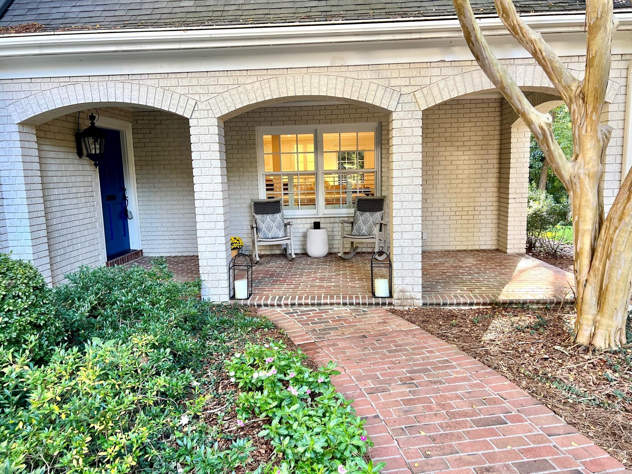 208 Walden Place Raleigh, NC 27609 - Photo 2 of 4 a front view of a house with a outdoor seating