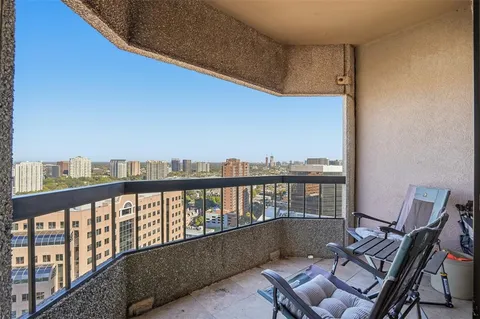 a balcony with wooden floor and outdoor seating