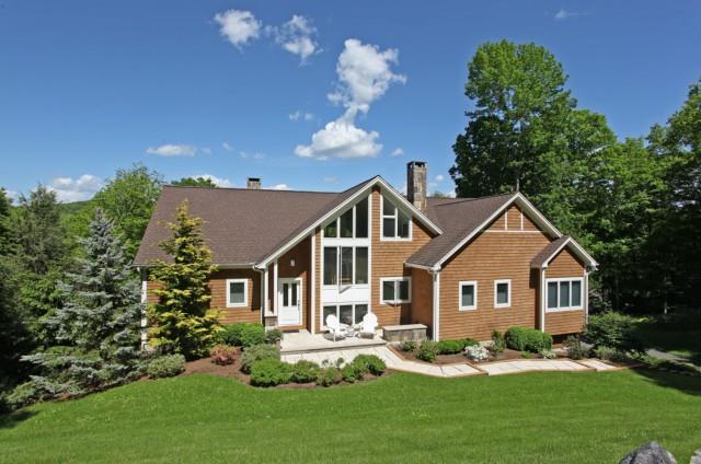 a front view of a house with a yard