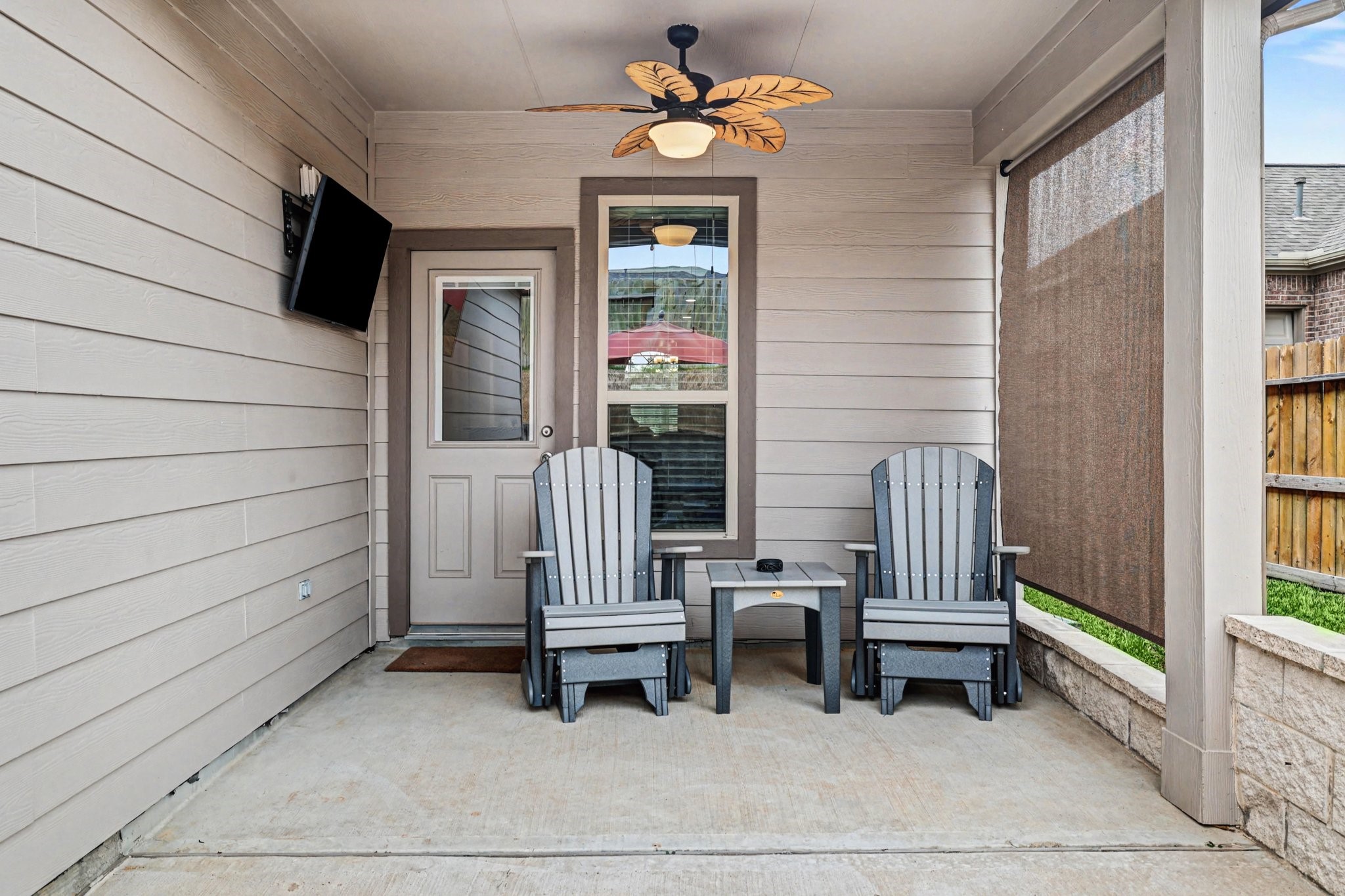 320 Red Maple Lane Conroe, TX 77304 - Photo 17 of 24 Private covered patio with fan, shade system, and integrated TV mounts.