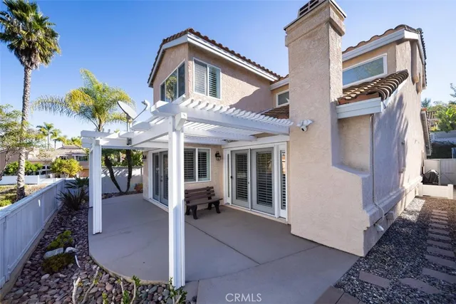 a view of a house with a patio and a yard