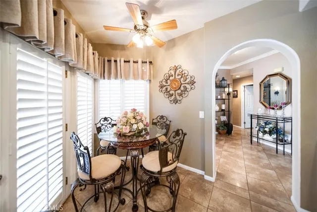 a view of a dining room with furniture and a chandelier