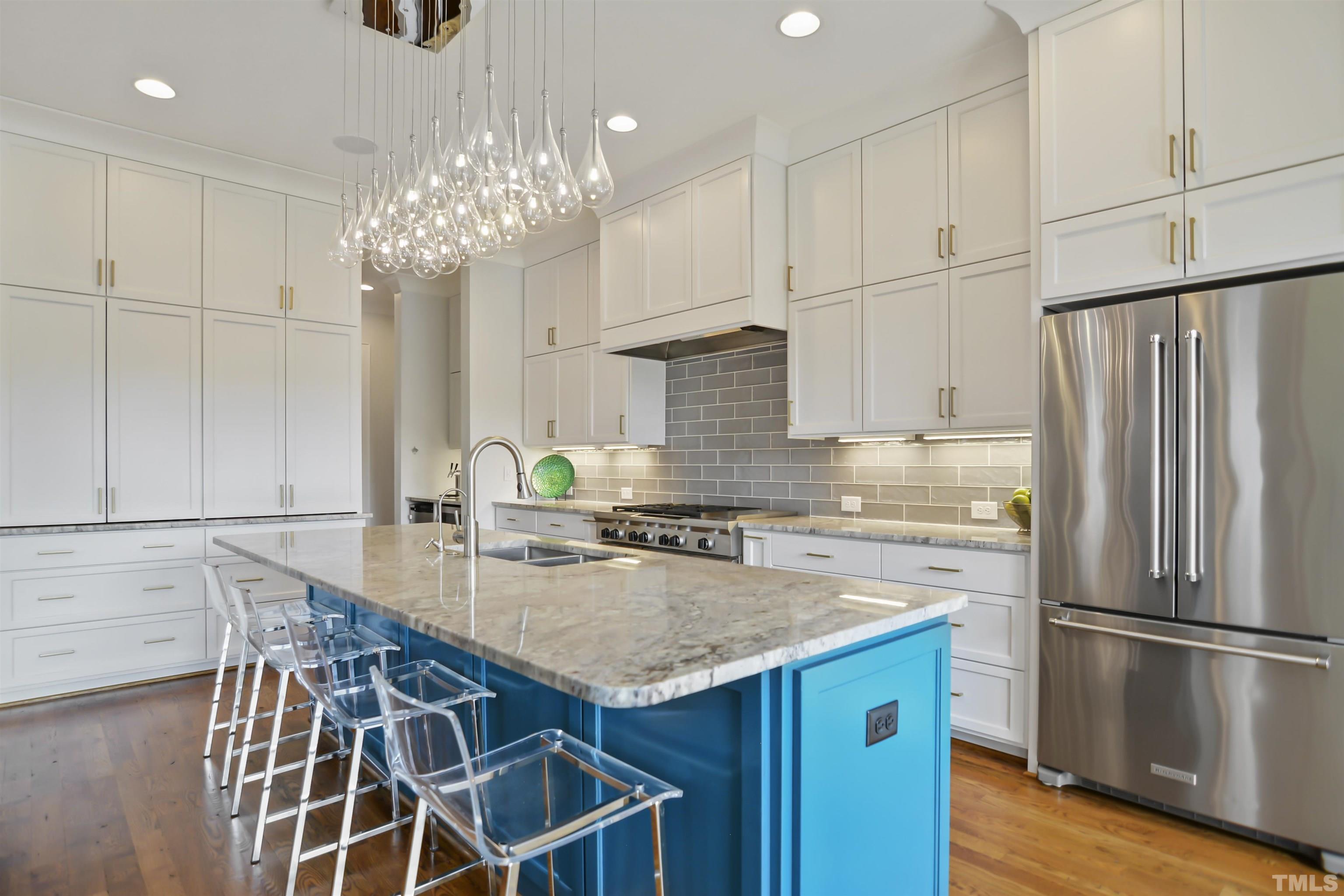 1012 Canterbury Road Raleigh, NC 27607 - Photo 11 of 51 a kitchen with kitchen island granite countertop stainless steel appliances a sink stove and refrigerator
