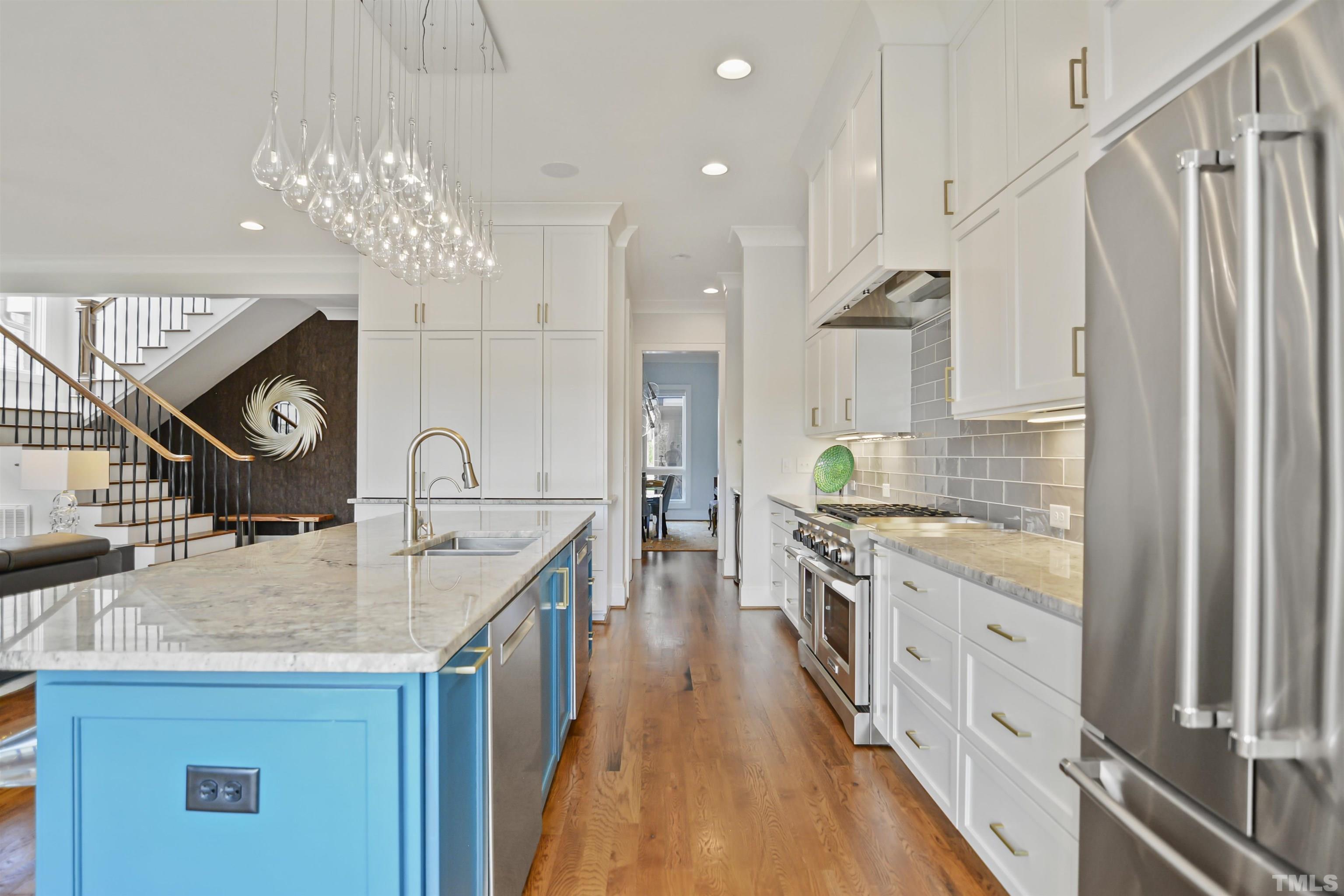 1012 Canterbury Road Raleigh, NC 27607 - Photo 12 of 51 a kitchen with kitchen island granite countertop lots of counter top space and stainless steel appliances