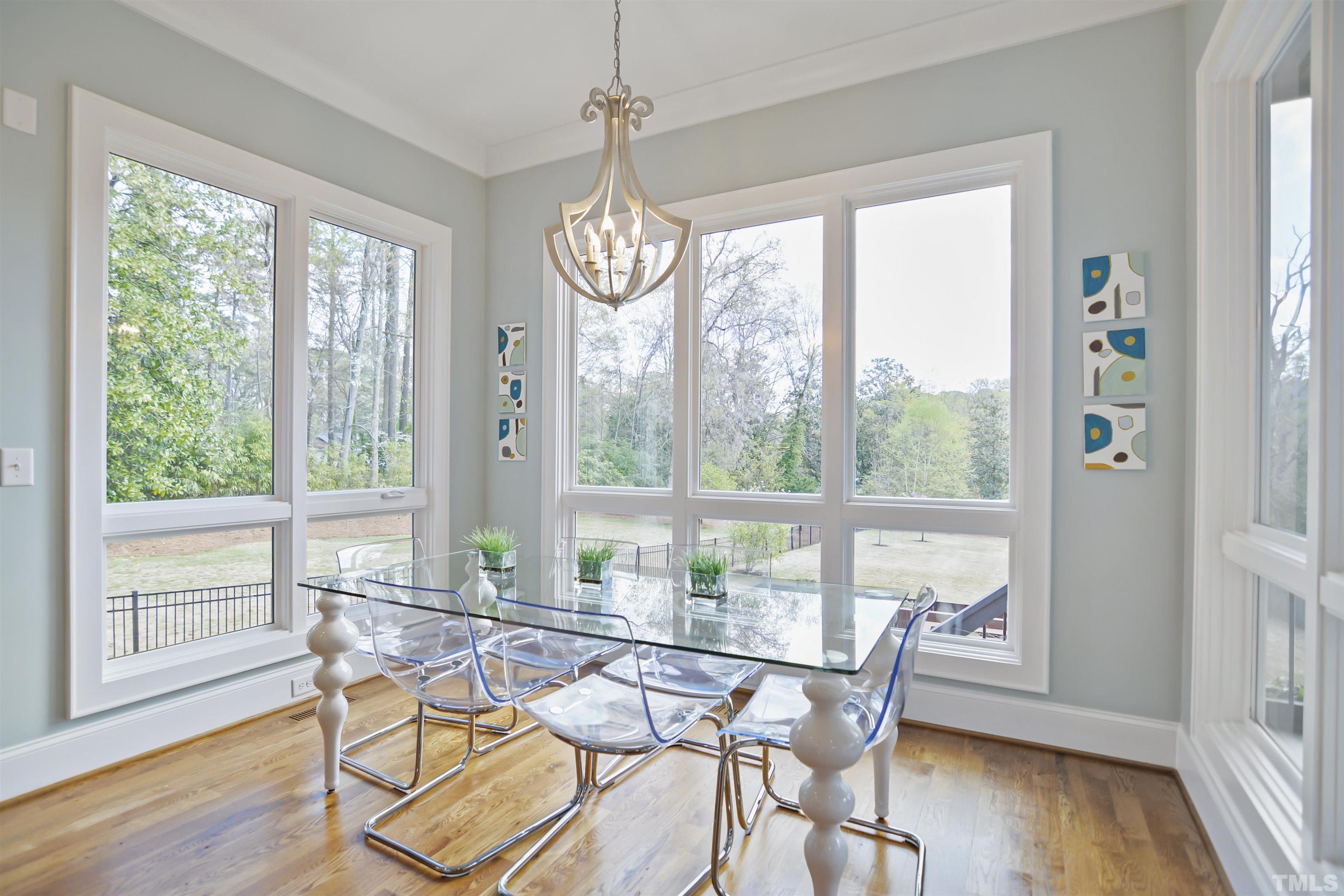 1012 Canterbury Road Raleigh, NC 27607 - Photo 16 of 51 a view of a dining room with furniture window and wooden floor
