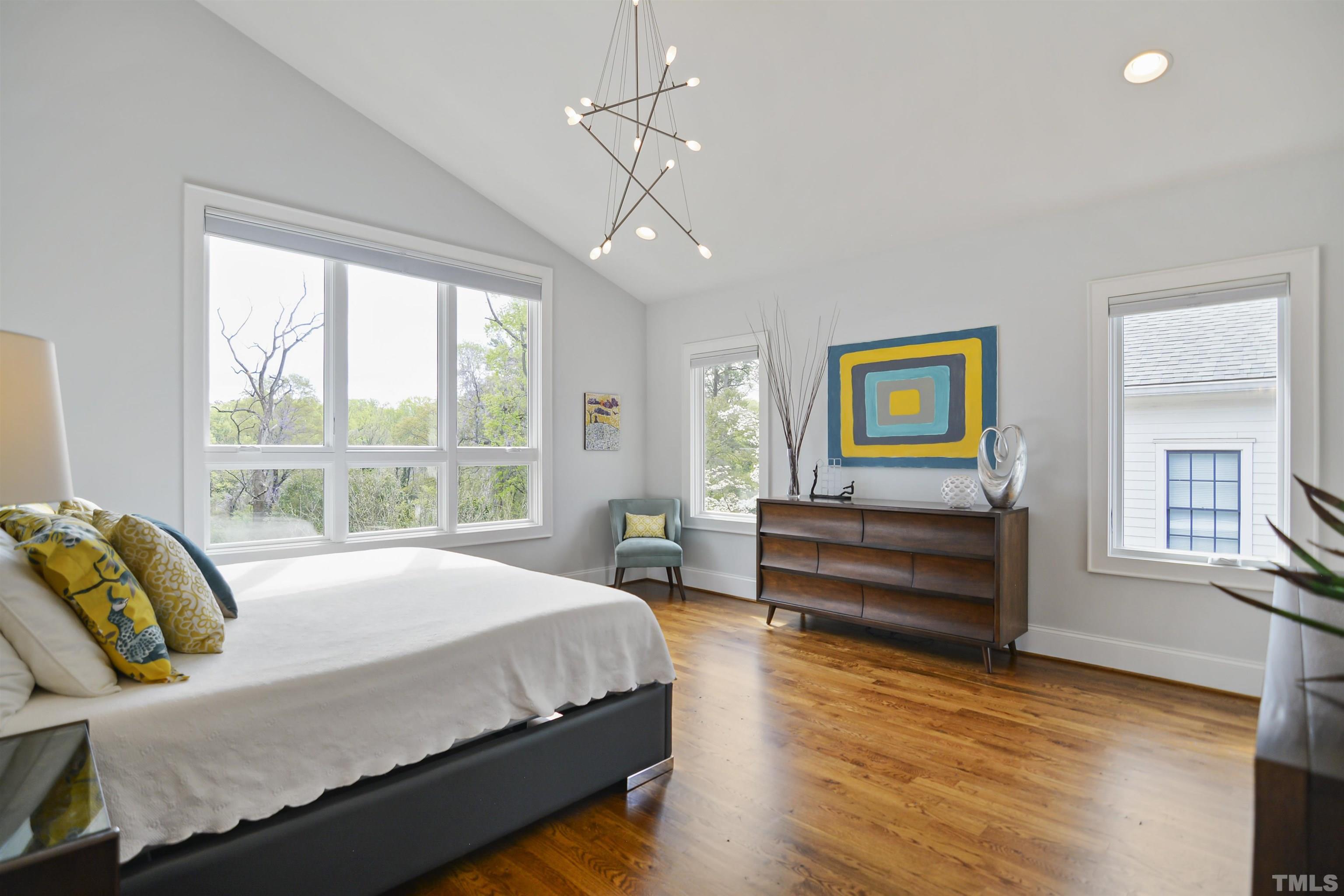 1012 Canterbury Road Raleigh, NC 27607 - Photo 18 of 51 a bedroom with a bed and wooden floor