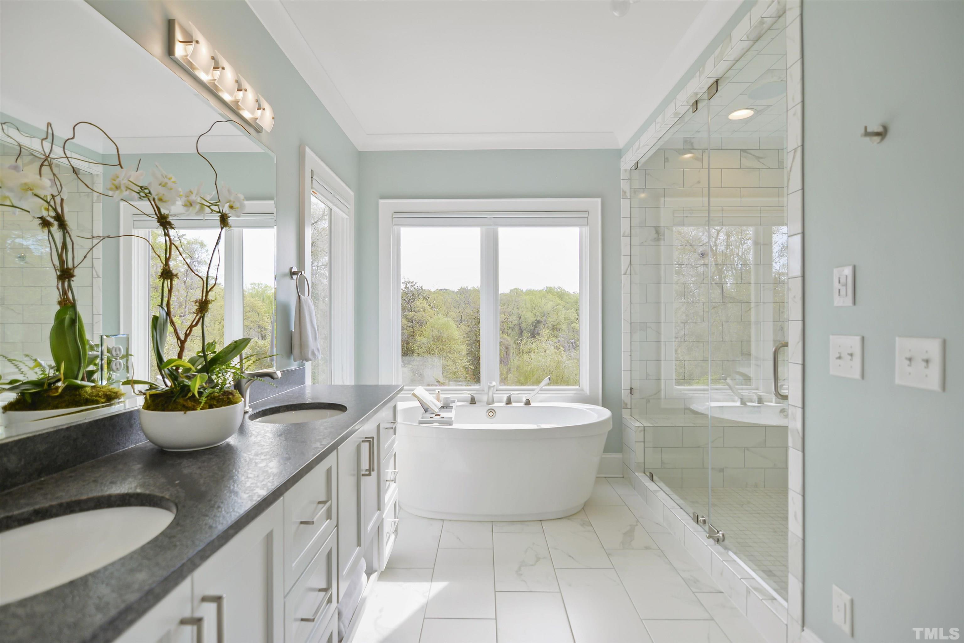 1012 Canterbury Road Raleigh, NC 27607 - Photo 20 of 51 a spacious bathroom with a bathtub sink and mirror