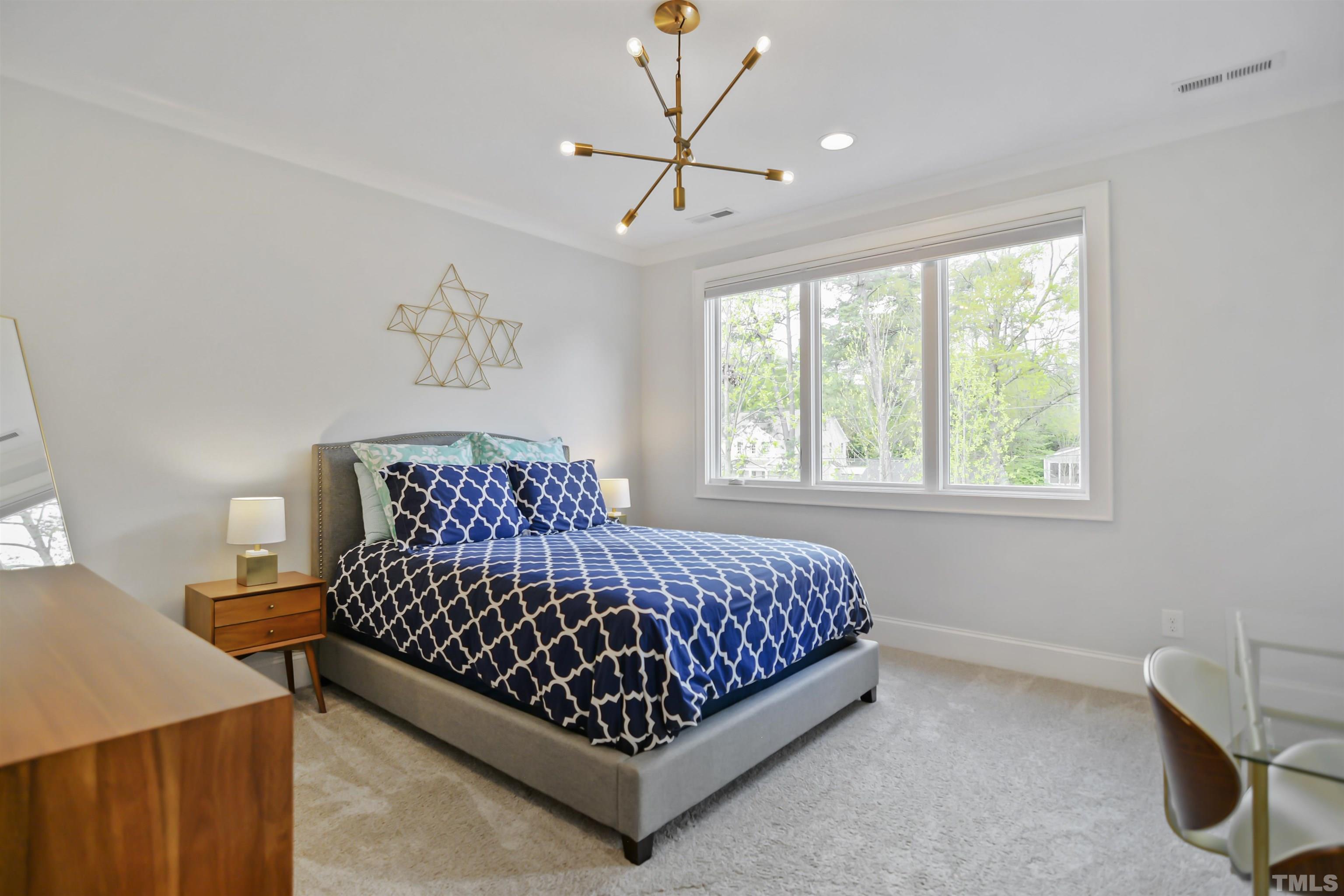 1012 Canterbury Road Raleigh, NC 27607 - Photo 22 of 51 a bed room with a bed and a chair