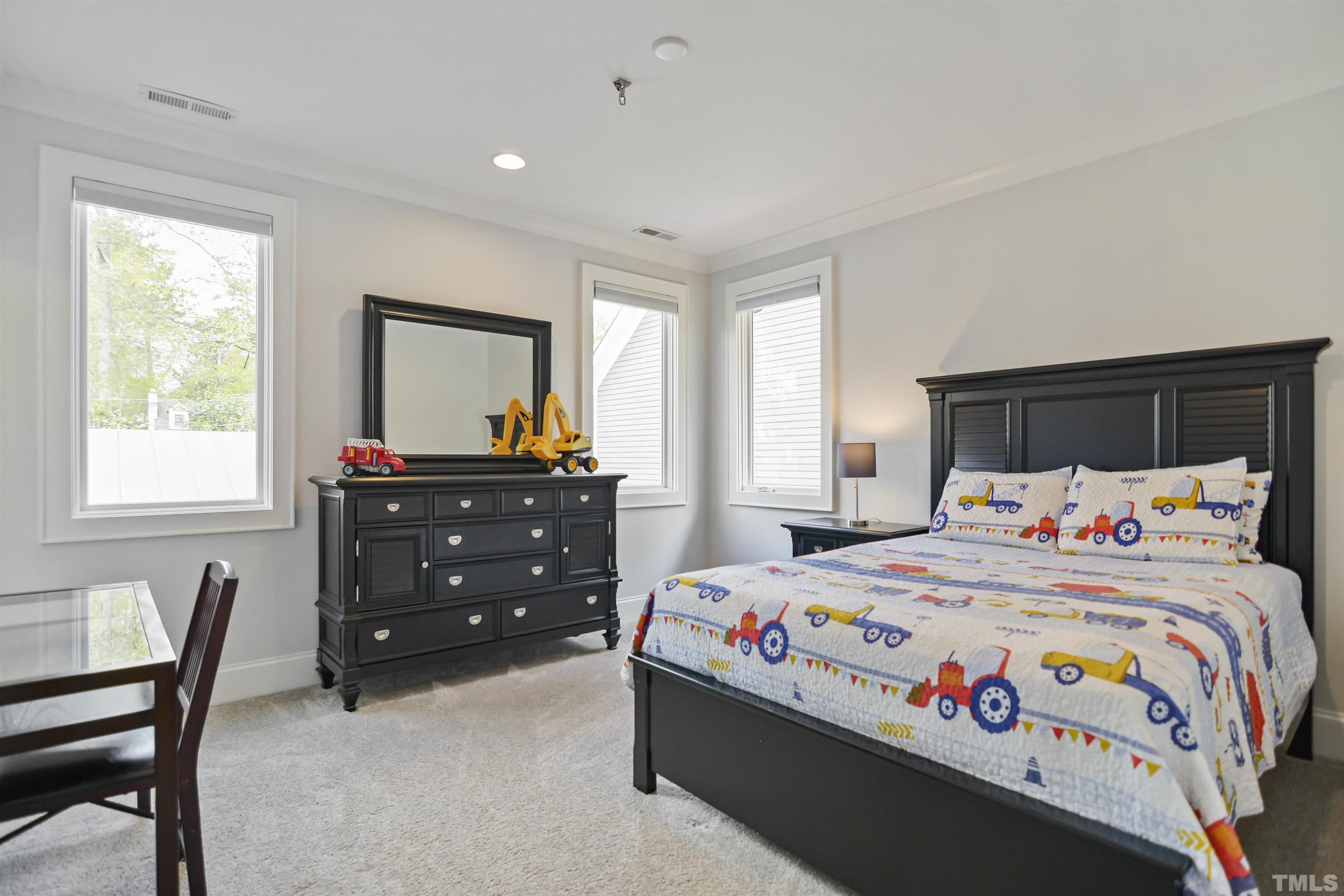 1012 Canterbury Road Raleigh, NC 27607 - Photo 23 of 51 a bedroom with a bed and a dresser