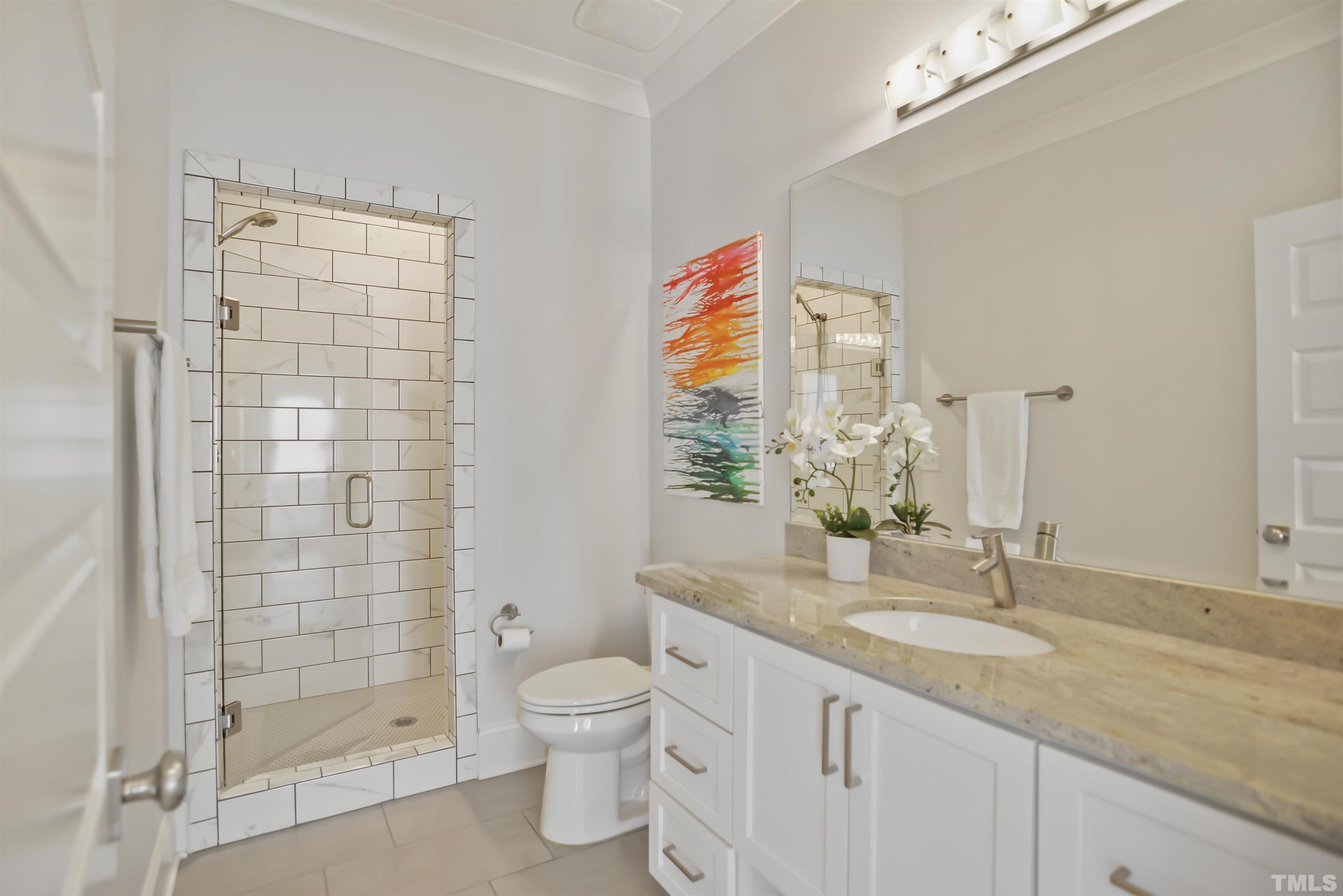 1012 Canterbury Road Raleigh, NC 27607 - Photo 25 of 51 a bathroom with a granite countertop sink a toilet and shower