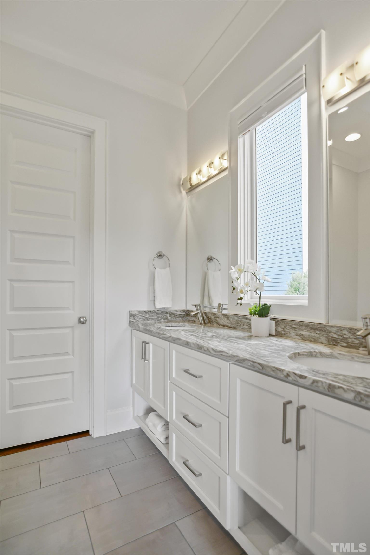 1012 Canterbury Road Raleigh, NC 27607 - Photo 27 of 51 a bathroom with a granite countertop sink and a mirror