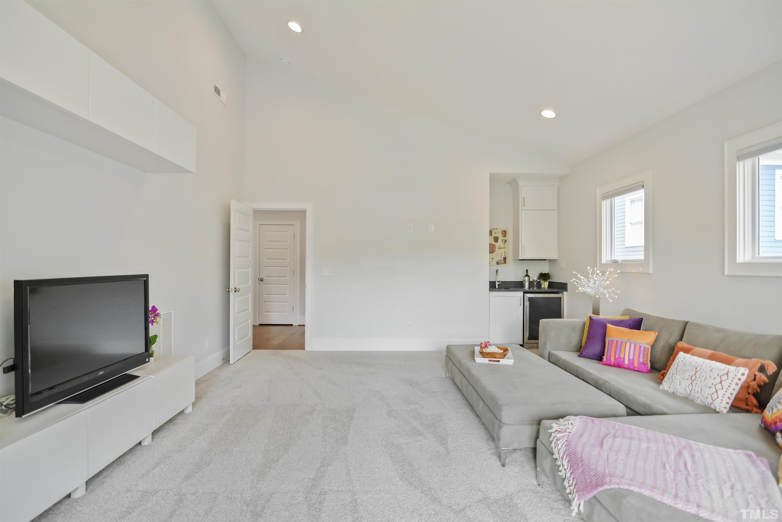 1012 Canterbury Road Raleigh, NC 27607 - Photo 31 of 51 a living room with furniture and a flat screen tv