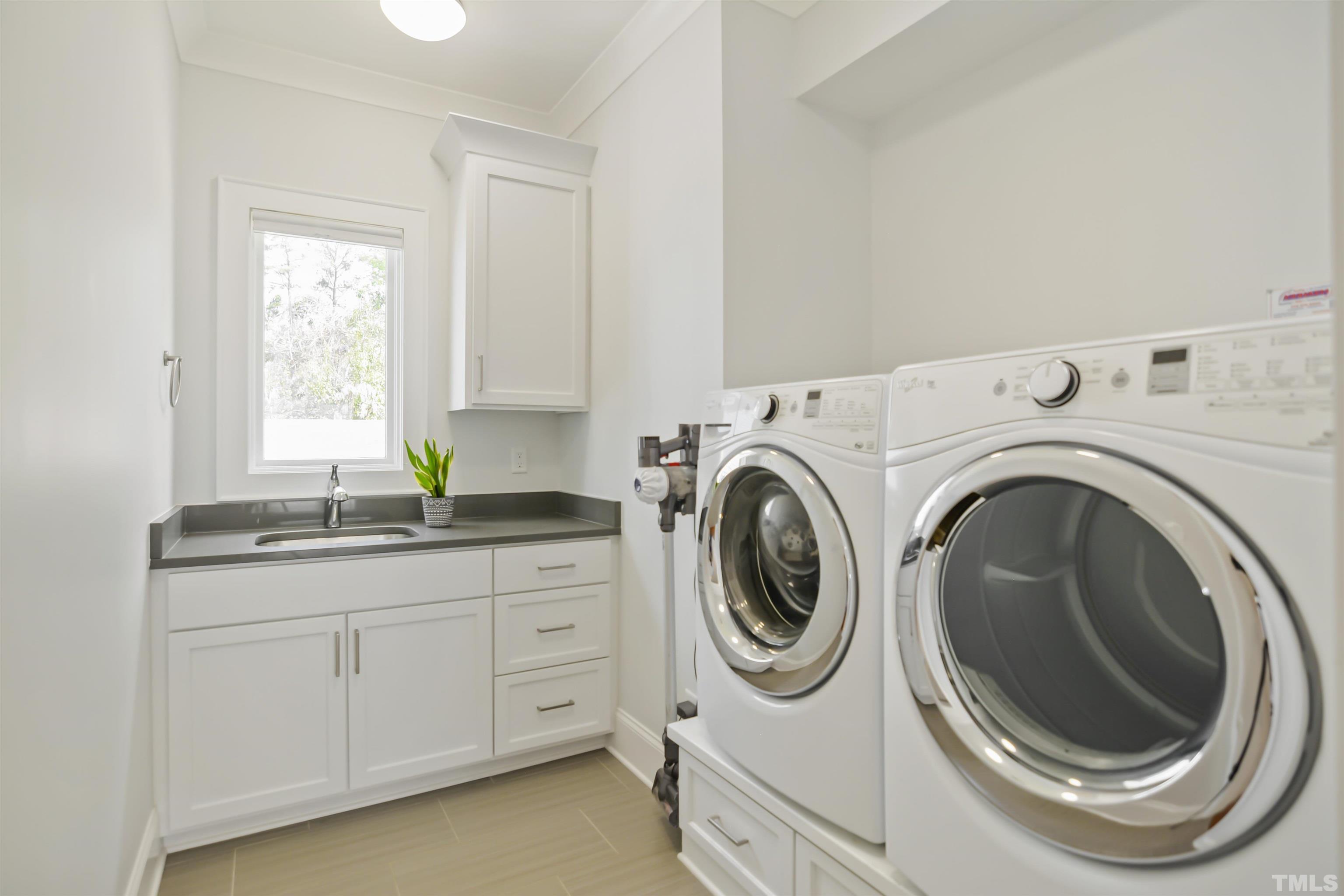 1012 Canterbury Road Raleigh, NC 27607 - Photo 32 of 51 a utility room with sink dryer and washer