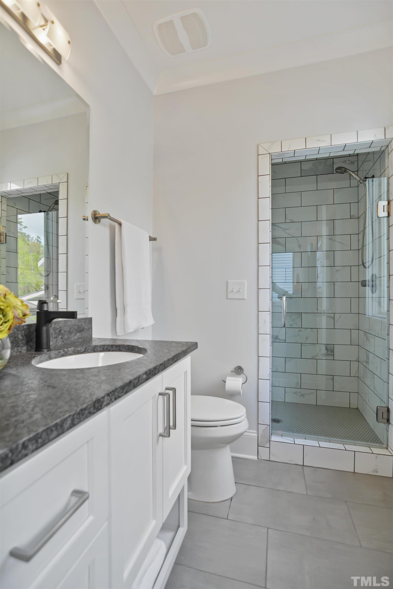 1012 Canterbury Road Raleigh, NC 27607 - Photo 35 of 51 a bathroom with a granite countertop sink a toilet and shower