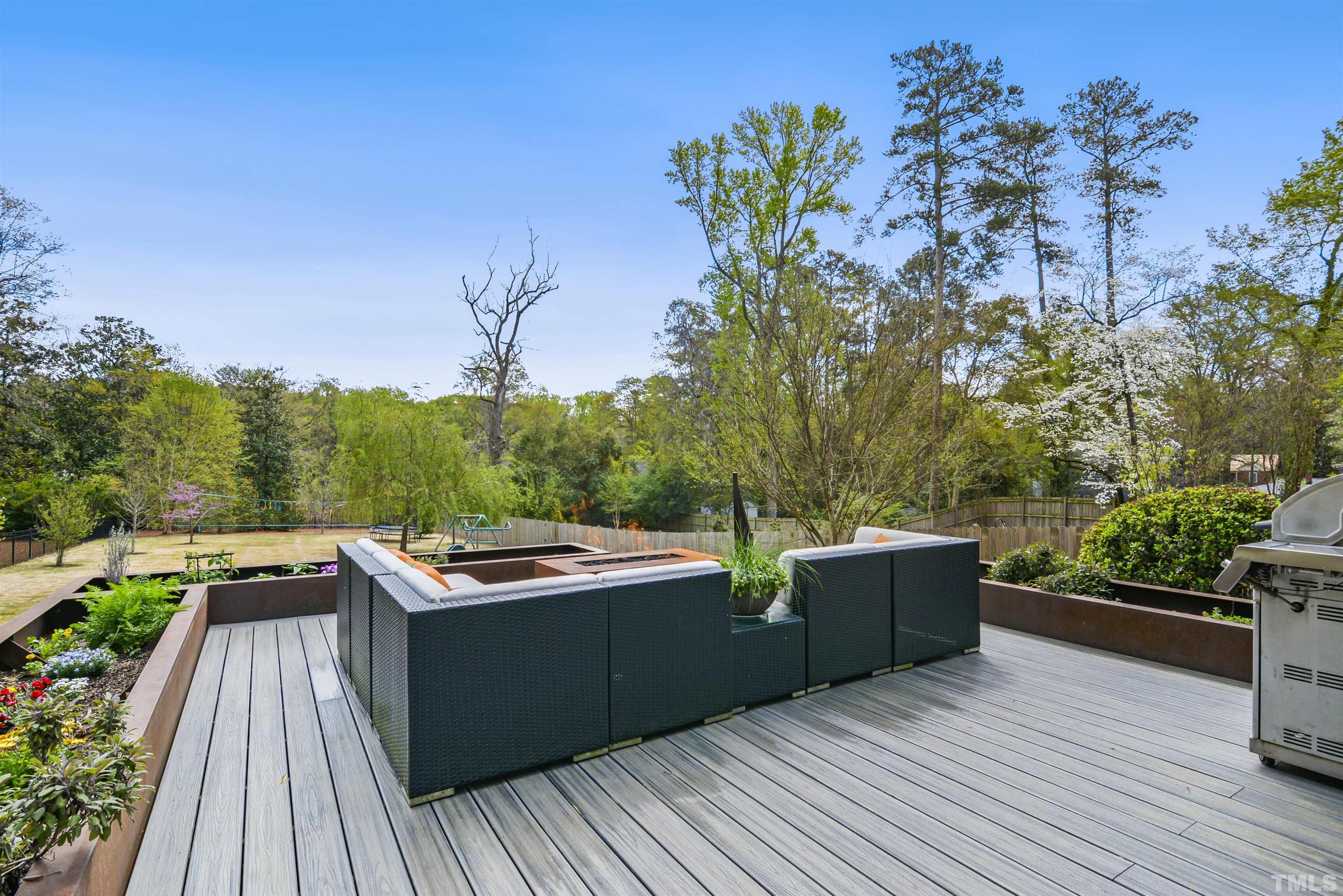 1012 Canterbury Road Raleigh, NC 27607 - Photo 41 of 51 a view of a wooden deck with a yard