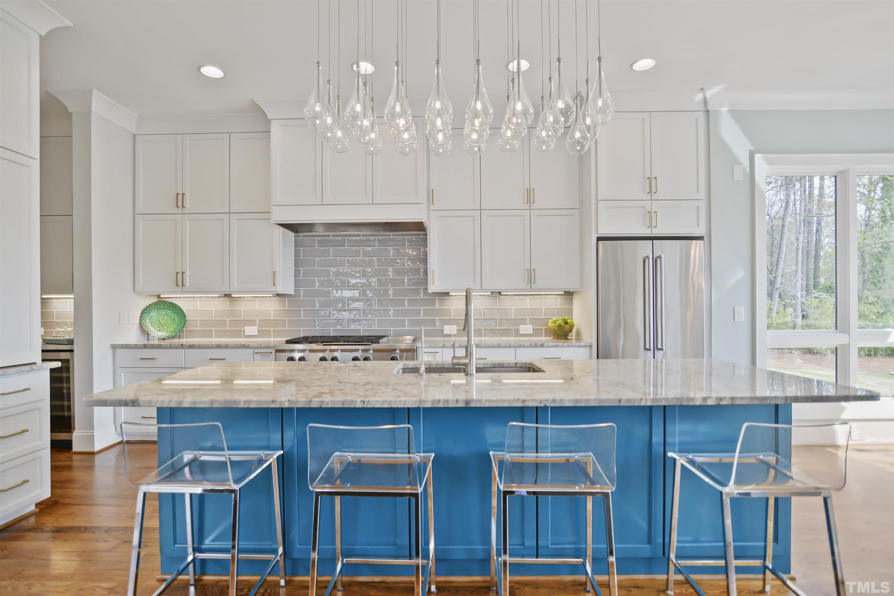 1012 Canterbury Road Raleigh, NC 27607 - Photo 10 of 51 a kitchen with cabinets and chairs