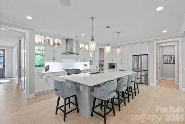 a dining hall with stainless steel appliances a dining table and chairs