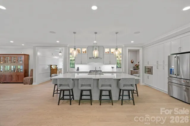 a large white kitchen with a large window and couch