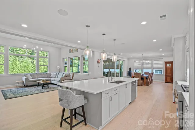 a dining room with furniture and a floor to ceiling window