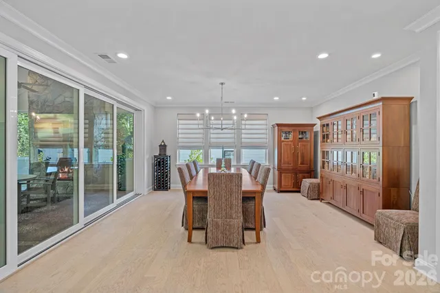 a dining room with furniture and a large window