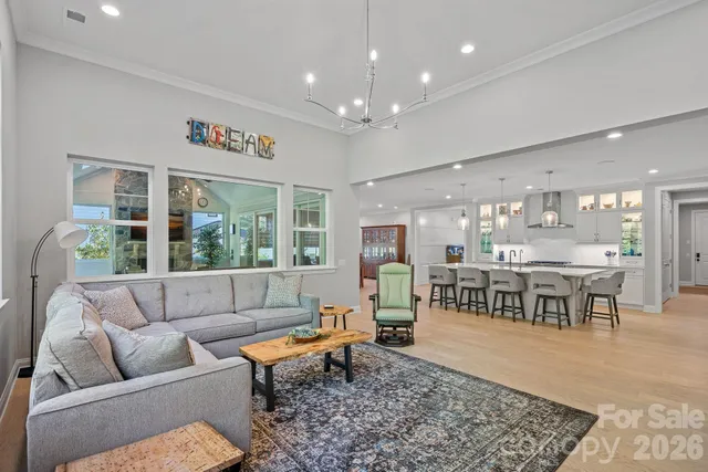a living room with fireplace furniture and a large window