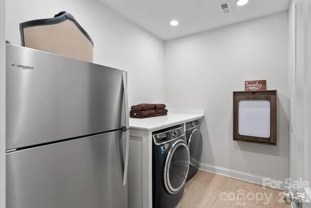 a bedroom with a bed a dresser next to a window