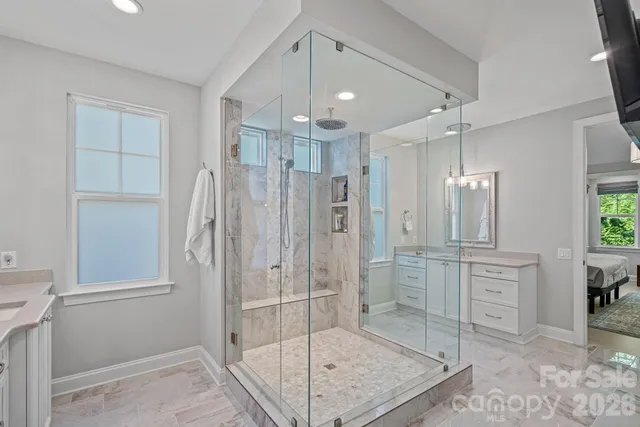 a living room with furniture a flat screen tv and a large window