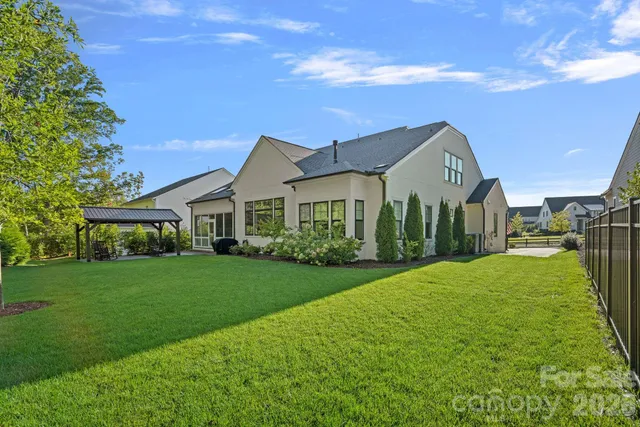 a front view of a house with a yard and green space