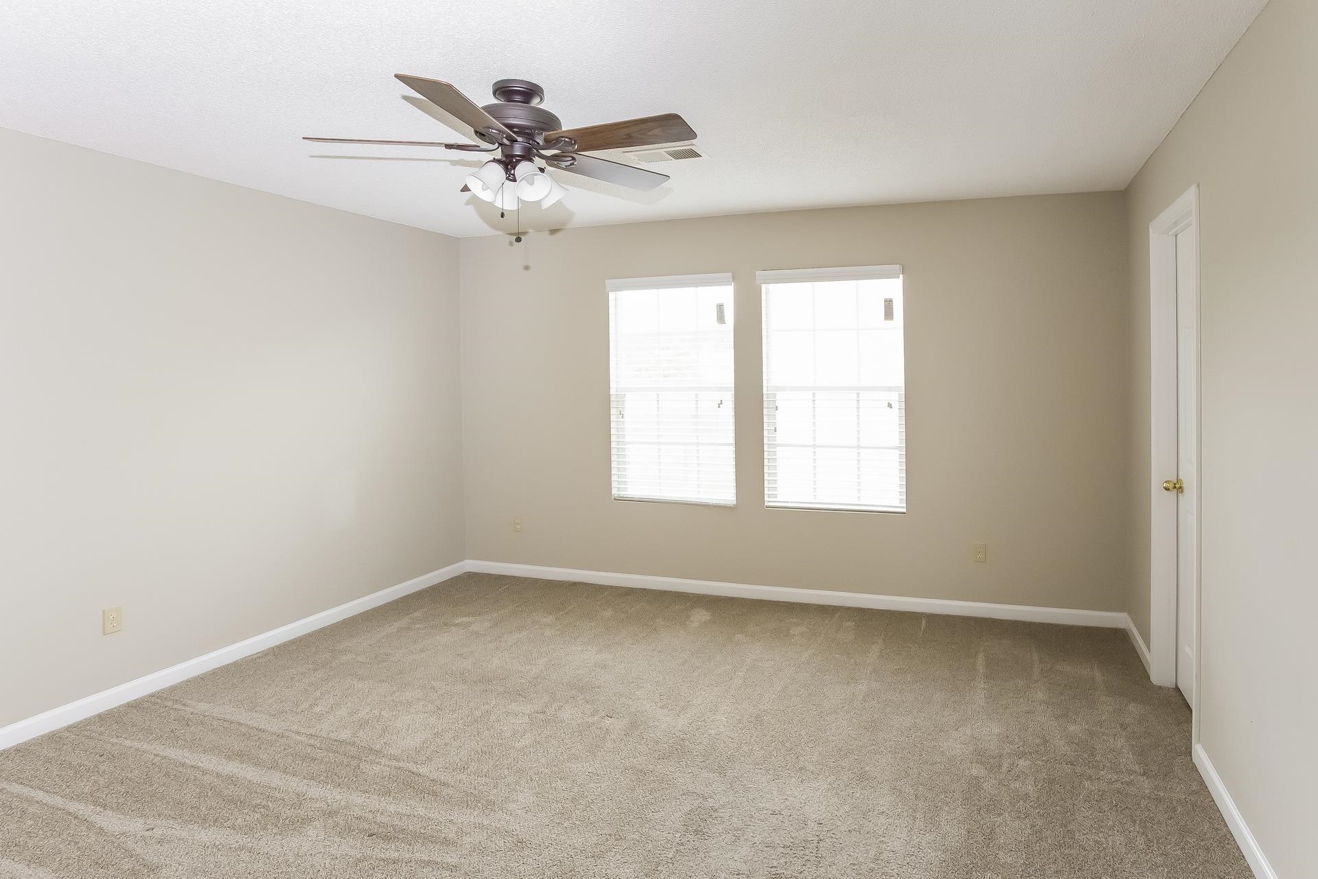 9966 Chariden Drive Cordova, TN 38016 - Photo 8 of 17 an empty room with a window and a ceiling fan