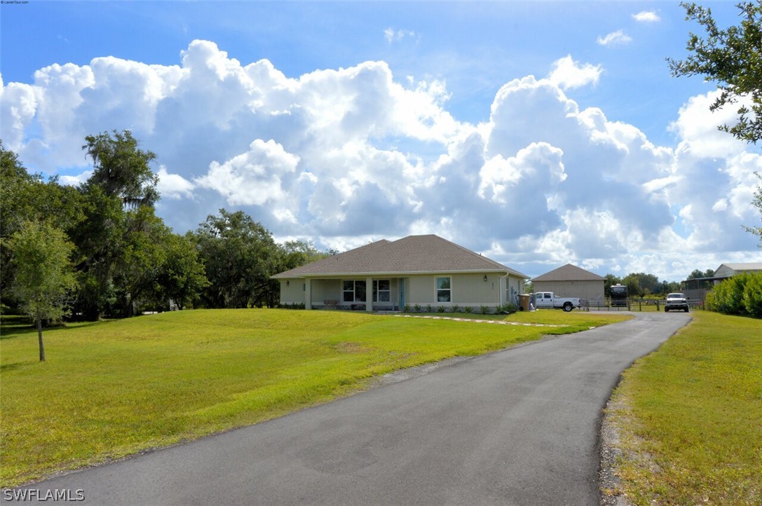 a view of a house with swimming pool and a yard