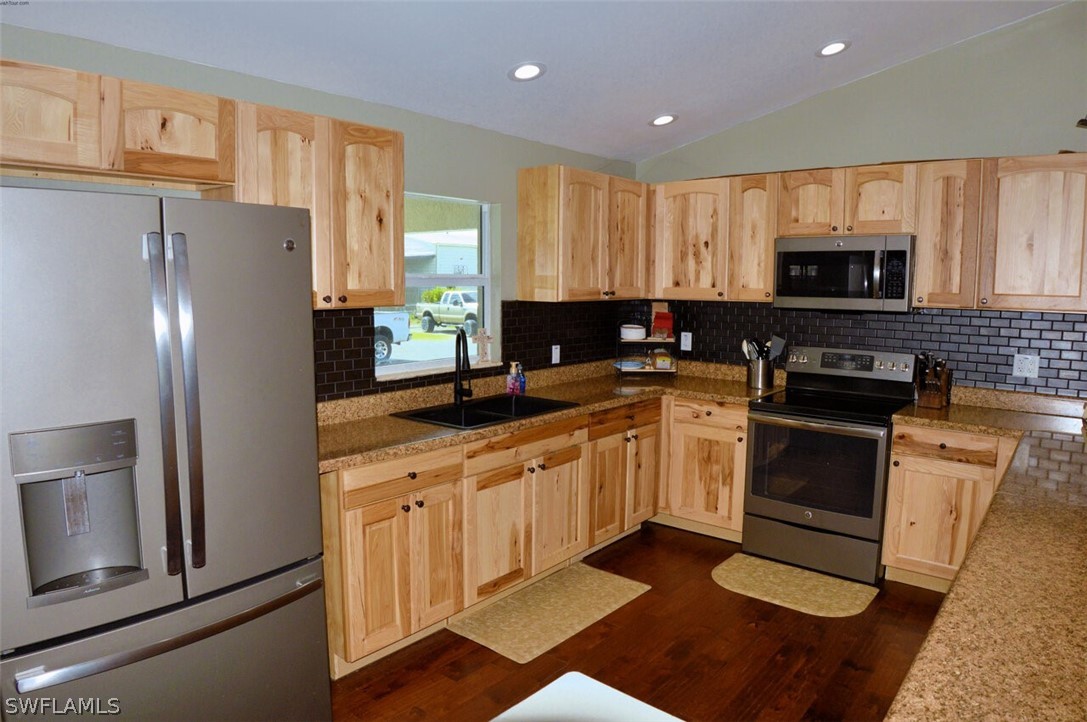 2041 Rialto Way Alva, FL 33920 - Photo 12 of 32 a kitchen with a refrigerator stove and microwave
