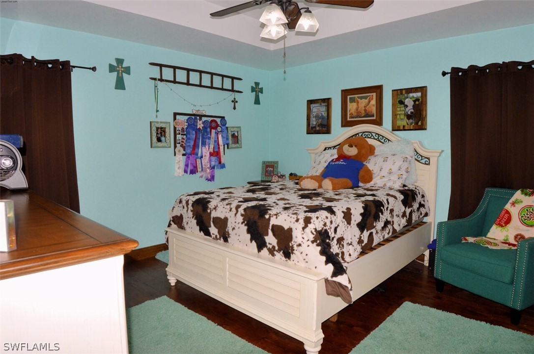 2041 Rialto Way Alva, FL 33920 - Photo 18 of 32 a bed sitting in a bedroom next to a window