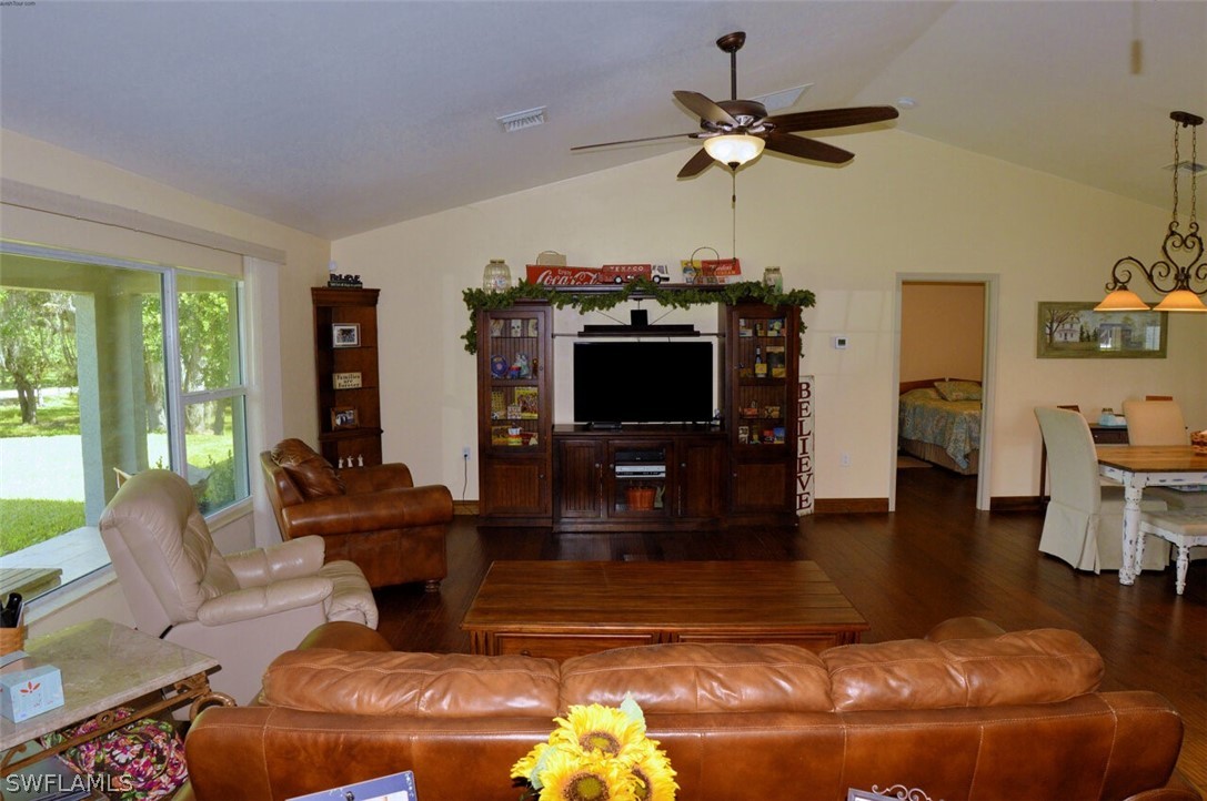 2041 Rialto Way Alva, FL 33920 - Photo 5 of 32 a living room with furniture a flat screen tv and a floor to ceiling window