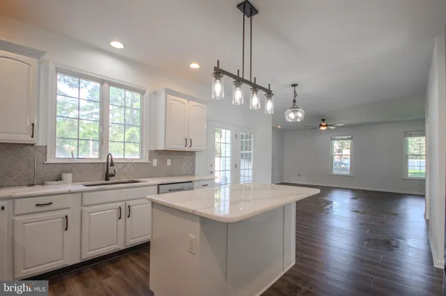 a view of hall way with furniture and a window