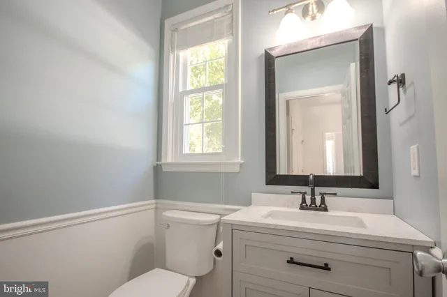 a view of staircase with white walls and white door
