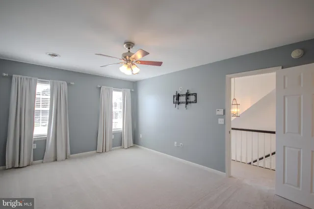 a view of a livingroom with a ceiling fan and window