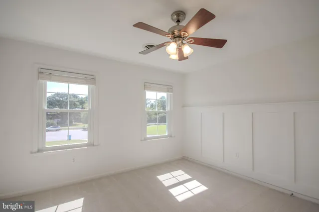 a view of a livingroom with a ceiling fan and window