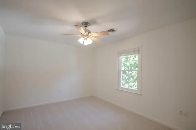 a view of a livingroom with a chandelier fan