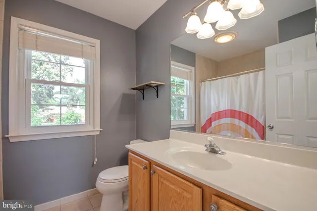 an empty room with closet and fan