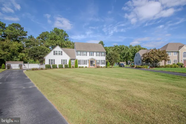 a view of house with outdoor space and garden