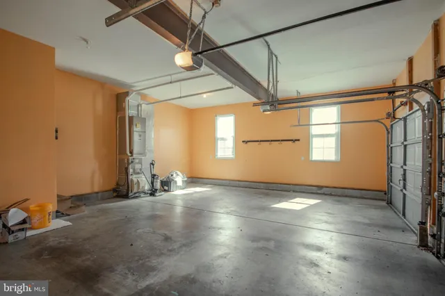 a view of swimming pool with lawn chairs and plants