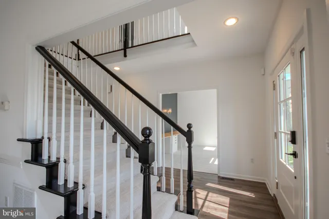 a view of an entryway with wooden floor and stairs