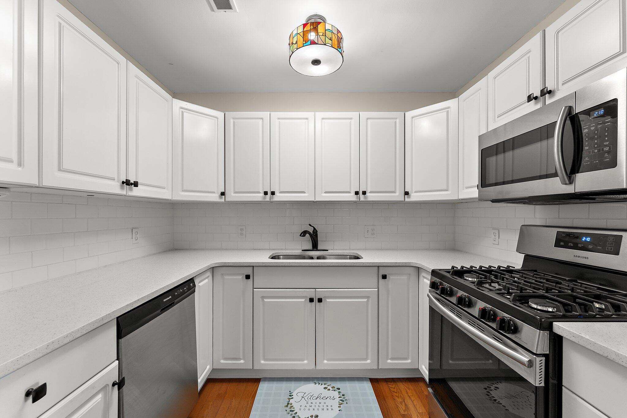 406 Sturdy Road, Unit 1A Valparaiso, IN 46383 - Photo 6 of 16 a kitchen with stainless steel appliances granite countertop a stove a sink and a white cabinets