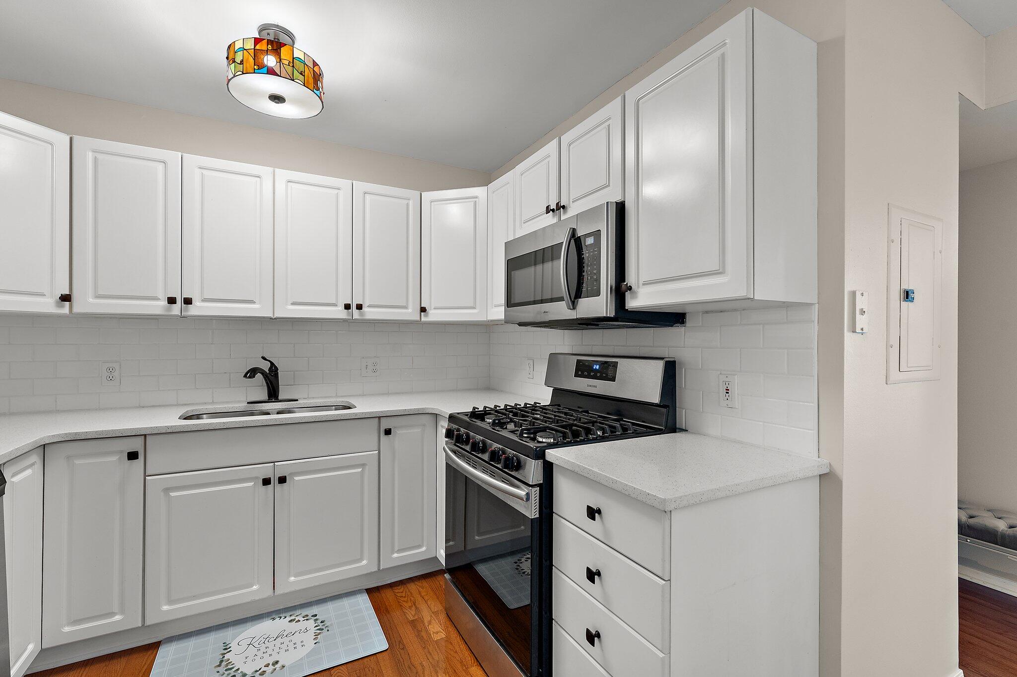 406 Sturdy Road, Unit 1A Valparaiso, IN 46383 - Photo 7 of 16 a kitchen with stainless steel appliances granite countertop a sink a stove and cabinets