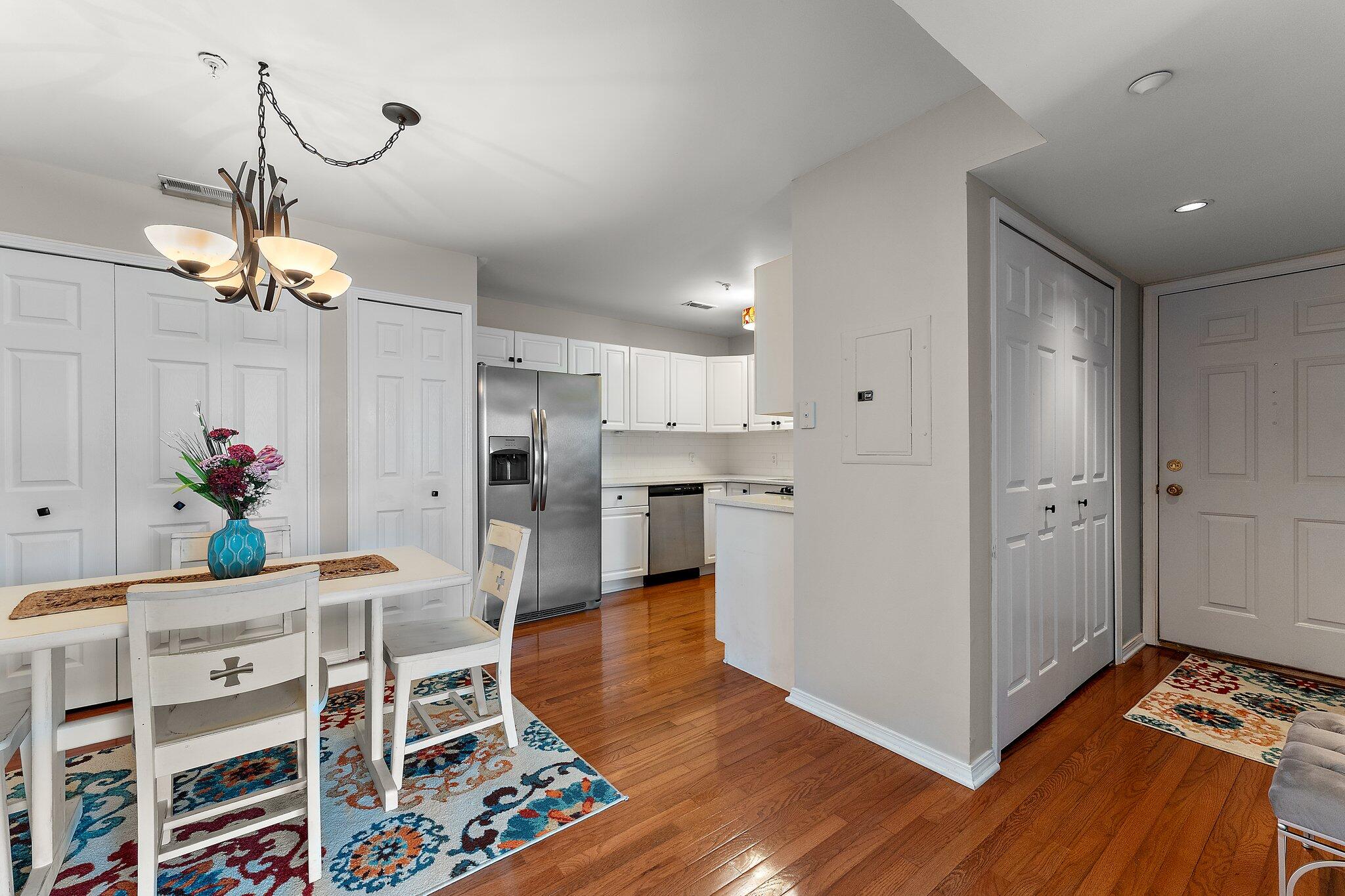 406 Sturdy Road, Unit 1A Valparaiso, IN 46383 - Photo 8 of 16 a kitchen with stainless steel appliances kitchen island granite countertop wooden cabinets and chandelier