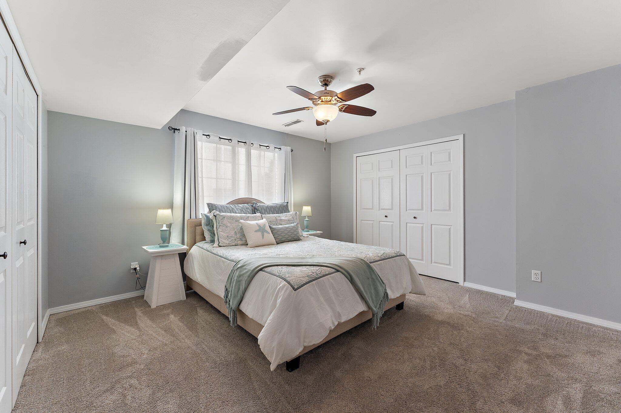 406 Sturdy Road, Unit 1A Valparaiso, IN 46383 - Photo 10 of 16 a spacious bedroom with a bed and a ceiling fan